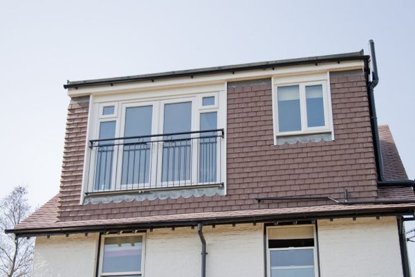 Tiled rear dormer with French doors and Juliet balcony on a loft conversion in Bushey Heath